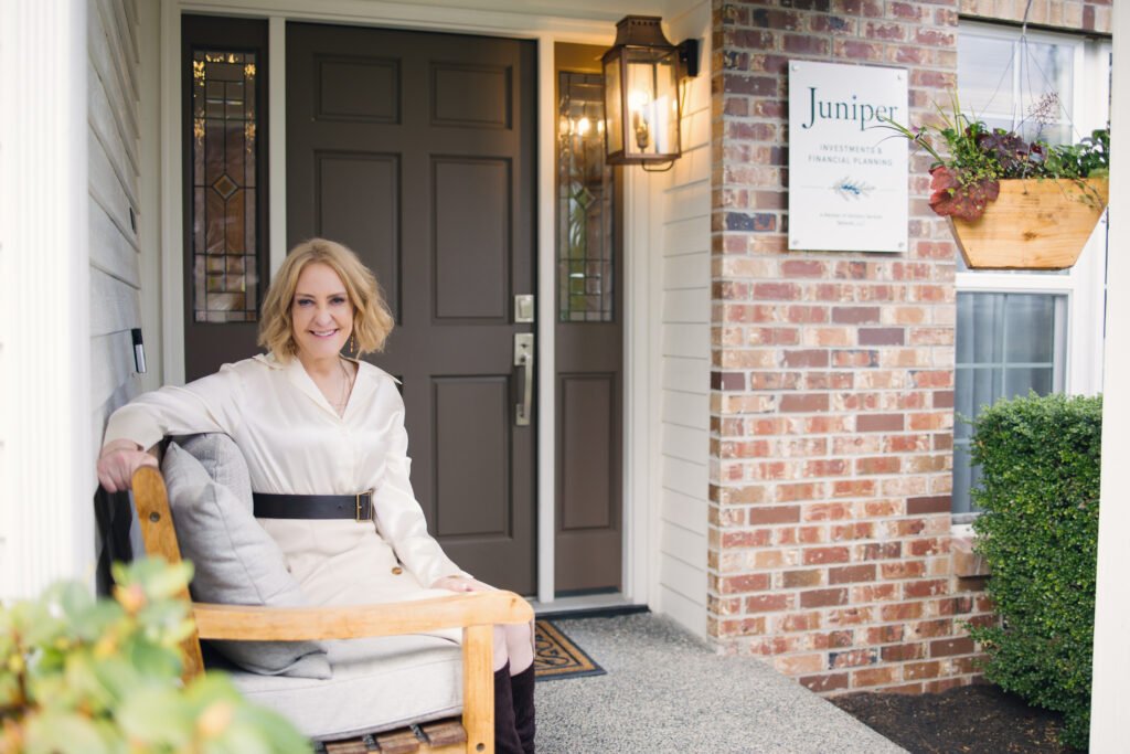 Julie Price seated outside the entrance to her office